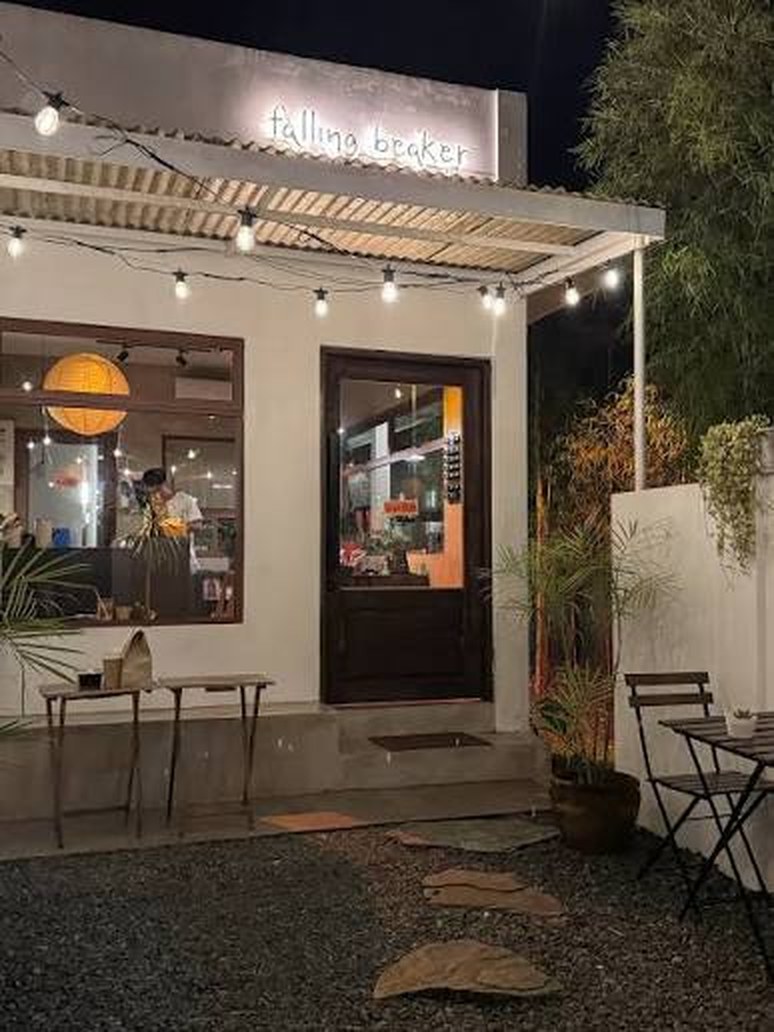 Falling Beaker, the cafe, lit up at night from the street